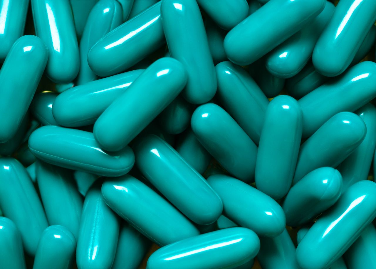 Close-up of turquoise capsules, ideal for pharmaceutical themes.